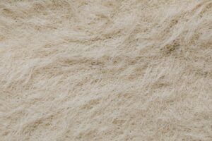 High-resolution close-up of a textured surface with beige natural fibers forming intricate patterns.